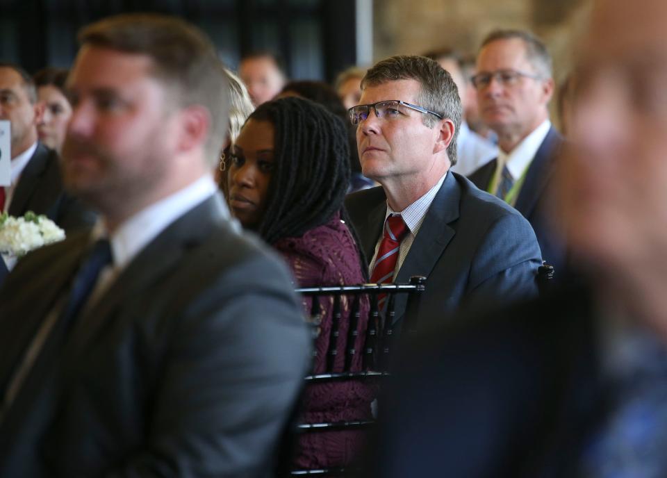 Tuscaloosa Mayor Walt Maddox listens as Alabama Governor Kay Ivey speaks during the Chamber of Commerce of West Alabama's State of the State event at Tuscaloosa River Market on  May 15, 2023.