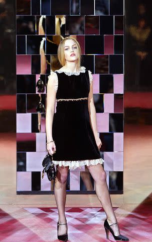 <p> PATRICK HERTZOG/AFP via Getty</p> Riley Keough wears a creation as part of Dolce and Gabbana's autumn/winter 2004-2005 women's collection, 28 February 2004 during Milan's fashion week.