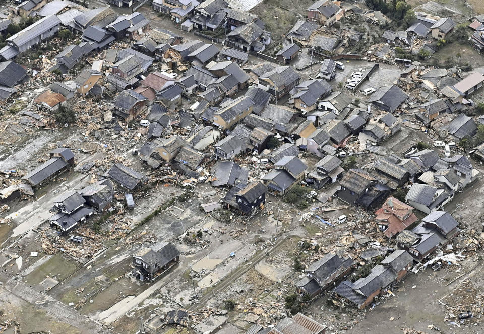 Destroyed houses along the coast are seen in Suzu, Ishikawa prefecture, Japan Tuesday, Jan. 2, 2024, following a series of powerful earthquakes hit western Japan. (Kyodo News via AP)