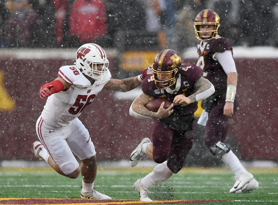 MINNEAPOLIS, MINNESOTA - NOVEMBER 30: Zack Baun #56 of the Wisconsin Badgers tackles Shannon Brooks #4 of the Minnesota Golden Gophers during the second quarter of the game at TCF Bank Stadium on November 30, 2019 in Minneapolis, Minnesota. (Photo by Hannah Foslien/Getty Images)