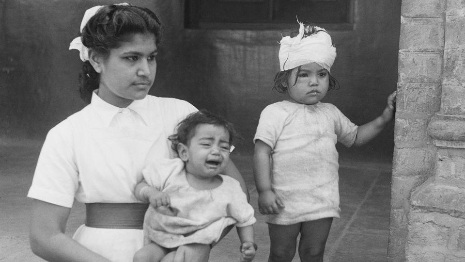 A nurse with two child victims of communal violence in Amritsar, Punjab, during the Partition of British India in 1947.  - Keystone Features/Hulton Archive/Getty Images/File