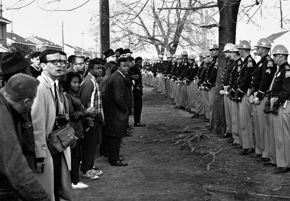 In this March 13, 1965 file photo, a line of police officers hold back demonstrators who attempted to march to the courthouse in Selma, Ala.