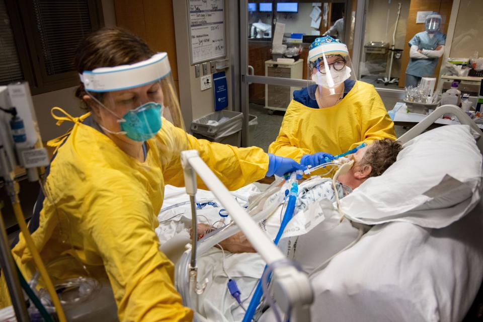 Respiratory therapist Sally Balvanz and ICU nurse Amy Olson remove the breathing tube to take a COVID-19 patient off the ventilator at Mary Greeley Medical Center in Ames on Dec. 7, 2020.