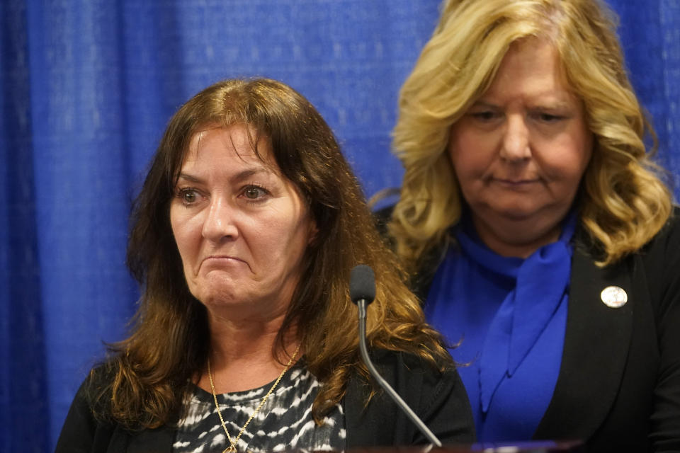 Nassau County District Attorney Anne Donnelly, right, stands with Darlene Altman, daughter of Diane Cusick, as she speaks during a news conference, Wednesday, June 22, 2022, in Mineola, N.Y. More than 50 years after a woman was found dead in her car at a mall on Long Island, authorities prosecutors are expected to announce that DNA evidence has linked the slaying to Richard Cottingham, a serial killer who has been connected to 11 murders in New York and New Jersey between 1965 and 1980. (AP Photo/Mary Altaffer)