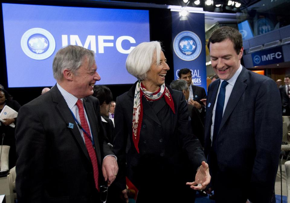 International Monetary Fund (IMF) Managing Director Christine Lagarde, center, speaks with Britain's Chancellor of the Exchequer George Osborne, right, and Governor of the Banque de France Christian Noyer, left, during the International Monetary and Financial Committee (IMFC) at World Bank Group-International Monetary Fund Spring Meetings in Washington, Saturday, April 12, 2014. ( AP Photo/Jose Luis Magana)