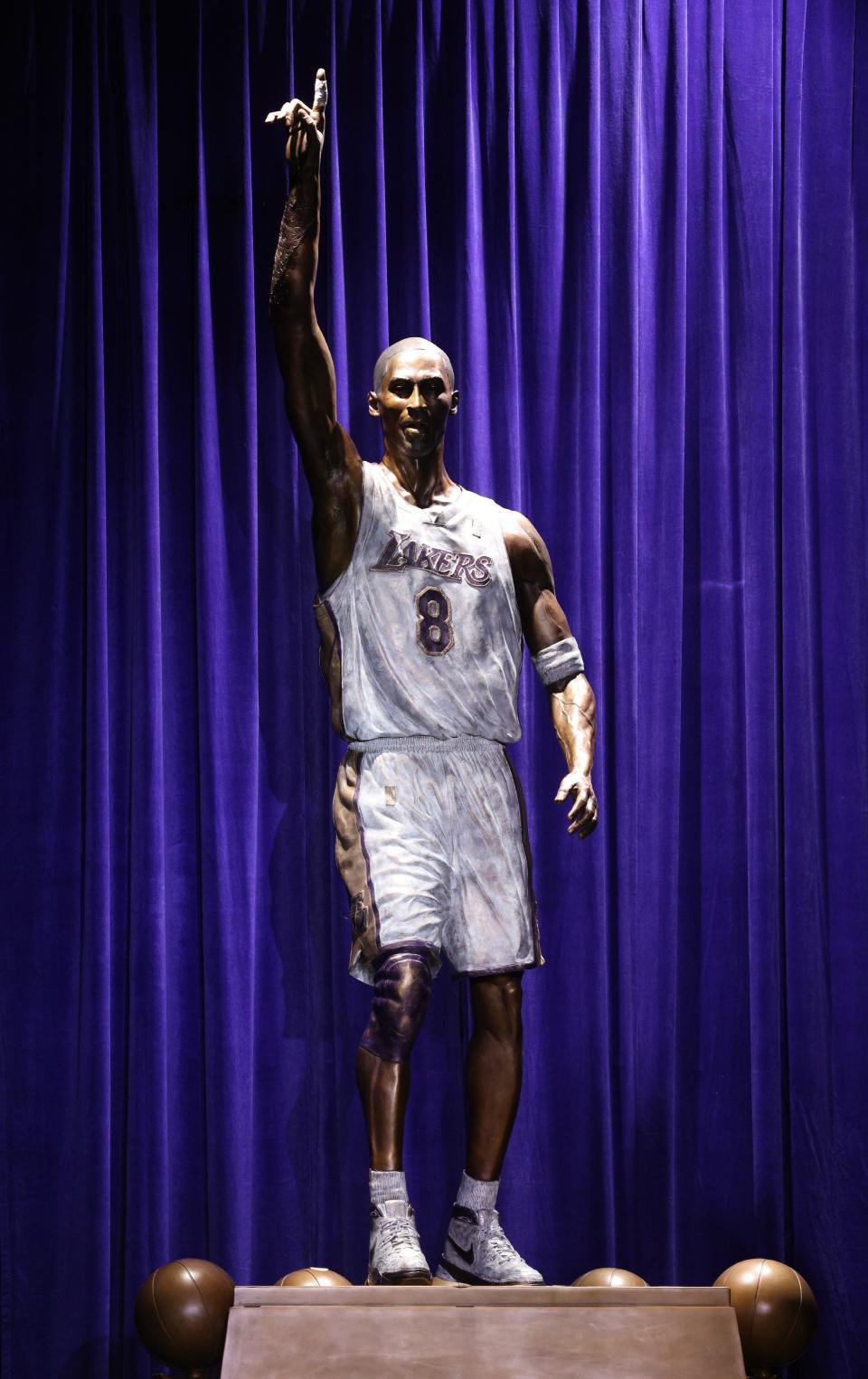 A statue of former Lakers guard Kobe Bryant is unveiled during a ceremony at Star Plaza outside of Crypto.com Arena.