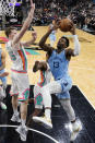 Memphis Grizzlies forward Jaren Jackson Jr. (13) drives to the basket against San Antonio Spurs center Jakob Poeltl (25) during the second half of an NBA basketball game, Wednesday, Jan. 26, 2022, in San Antonio. (AP Photo/Eric Gay)