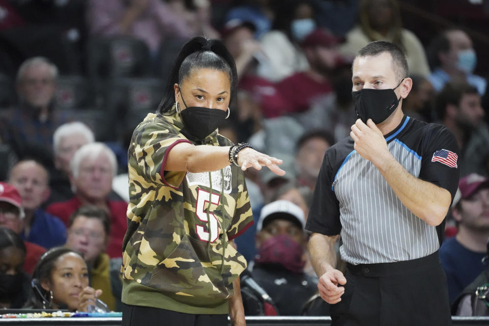 South Carolina head coach Dawn Staley, left, talks with an official during the second half of an NCAA college basketball game Friday, Nov. 26, 2021, in Columbia, S.C. (AP Photo/Sean Rayford)