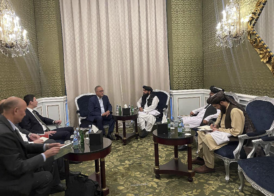In this photo released by the Taliban Spokesman Office, Zabihullah Mujahid, the chief spokesman for the Taliban government who leads the Taliban delegation, center right, speaks with Uzbekistan Presidential Envoy to Afghanistan Ismatullah Irgashev, during a meeting in Doha, Qatar, Sunday, June 30, 2024. A Taliban delegation is attending a United Nations-led meeting in Qatar on Afghanistan after organizers said women would be excluded from the gathering. The two-day meeting is the third U.N.-sponsored gathering on the Afghan crisis. (Taliban Spokesman Office via AP)