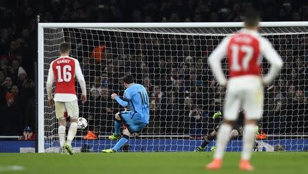 Football Soccer - Arsenal v FC Barcelona - UEFA Champions League Round of 16 First Leg - Emirates Stadium, London, England - 23/2/16. Lionel Messi scores the second goal for Barcelona from the penalty spot. REUTERS/Dylan Martinez/Livepic