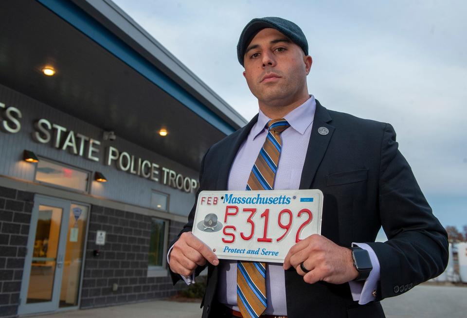 Patrick McNamara, president of the State Police Association of Massachusetts, holds a "Protect and Serve" specialty license plate at the Weston Police Barracks, Nov. 15, 2023. The plate is part of a fundraising effort for the Benevolent Fund, which was established to provide resources to the first responder community, including state and local police, firefighters and MBTA Transit Police.