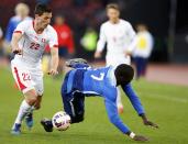 Jozy Altidore of the U.S (R) falls next to Fabian Schar of Switzerland during their international friendly soccer match at the Letzigrund Stadium in Zurich March 31, 2015. REUTERS/Arnd Wiegmann