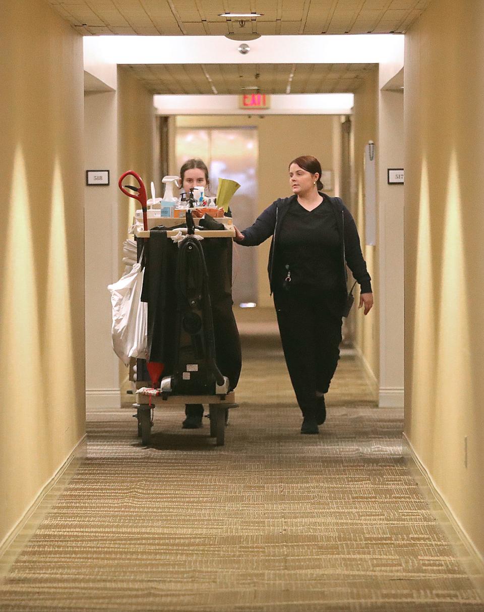 Sheraton Suites suite attendant Jessica Tidwell, left, and suite inspector Tasha Christy set out to clean rooms on Friday. The 209-room hotel in Cuyahoga Falls is sold out for both Sunday and Monday nights.