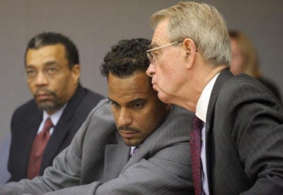 Jayson Williams, center, listens to his attorney Joseph Hayden during a hearing before Judge Coleman in Superior Court in Somerville. At left is another attorney Billy Martin.