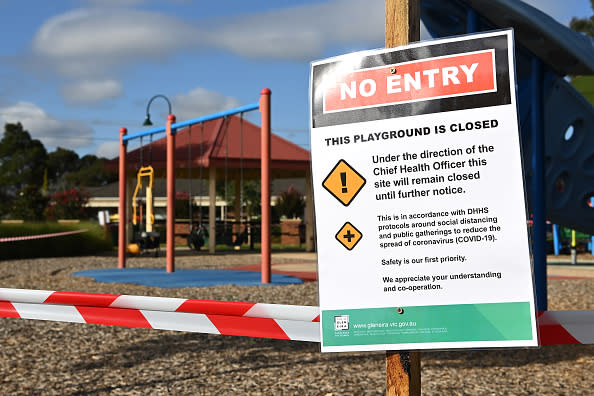 An information notice stating the closure of outdoor playground equipment is seen in Melbourne.