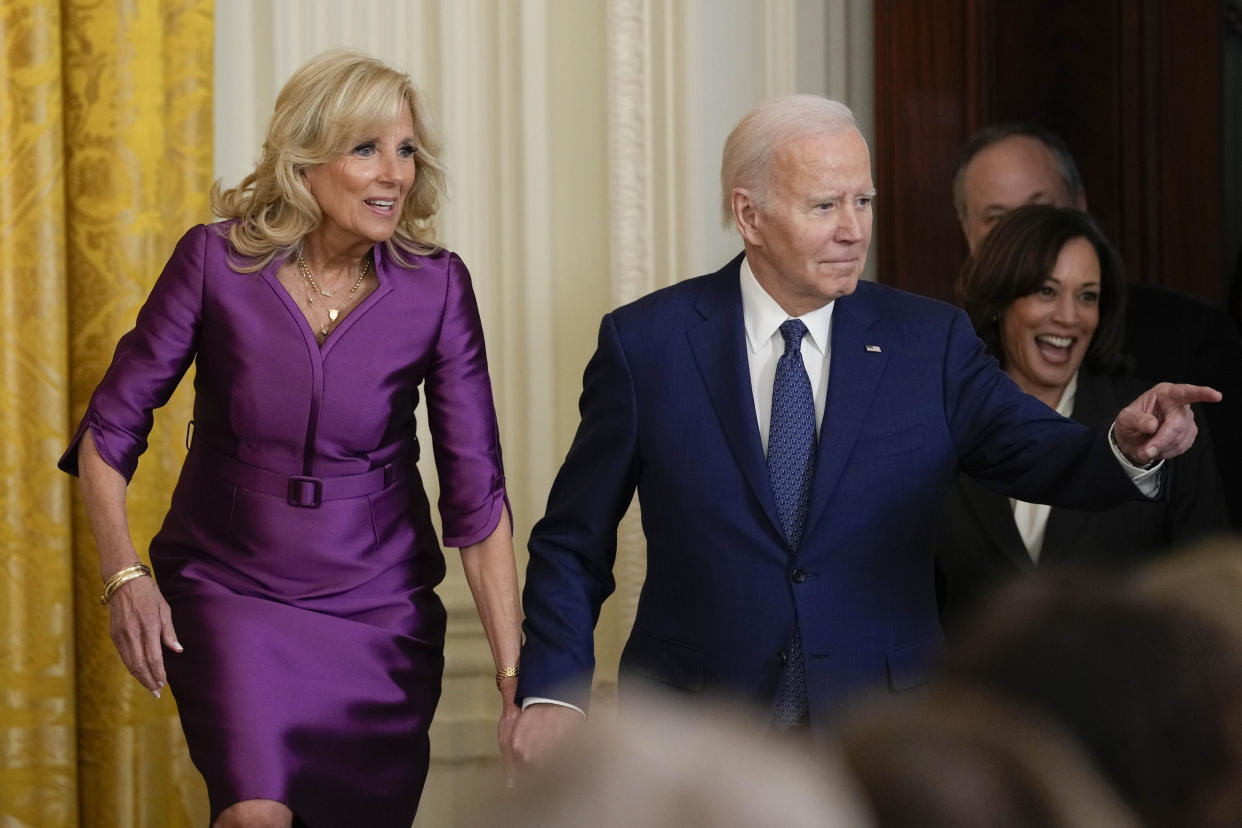 First lady Jill Biden, President Joe Biden, Vice President Kamala Harris and her husband Doug Emhoff arrive for an event in the East Room of the White House in Washington, Wednesday, March 22, 2023, to celebrate women's history month. (AP Photo/Susan Walsh)