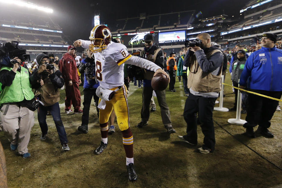 FILE - Washington Redskins' Kirk Cousins reacts as he walks off the field after Washington defeated the Philadelphia Eagles 38-24 in an NFL football game Saturday, Dec. 26, 2015, in Philadelphia. Cousins returns to play Washington as a visiting quarterback for the first time with the 6-1 Minnesota Vikings facing the Commanders. (AP Photo/Matt Rourke, File)