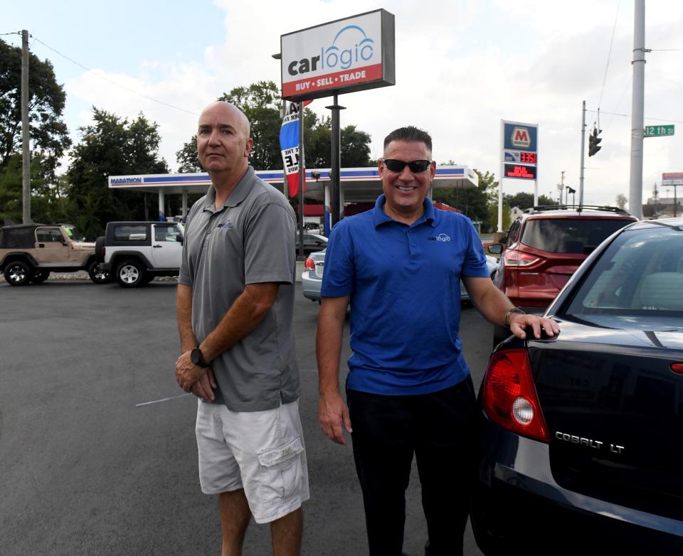 Ron Winters, left, and business partner Michael France sell used cars at Car Logic at 1202 Whipple Ave. NW in Canton Township.