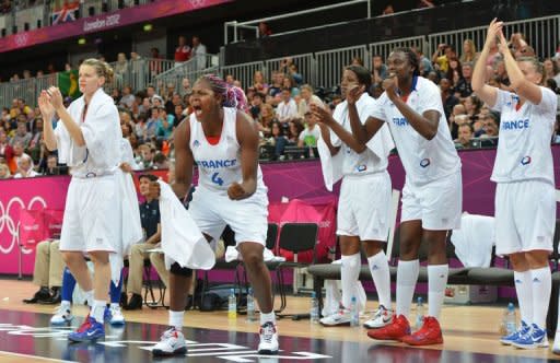 French players cheer their teammates during the Women's preliminary round group B basketball match of the London 2012 Olympic Games France vs Australia at the basketball arena in London. France won 74 to 70