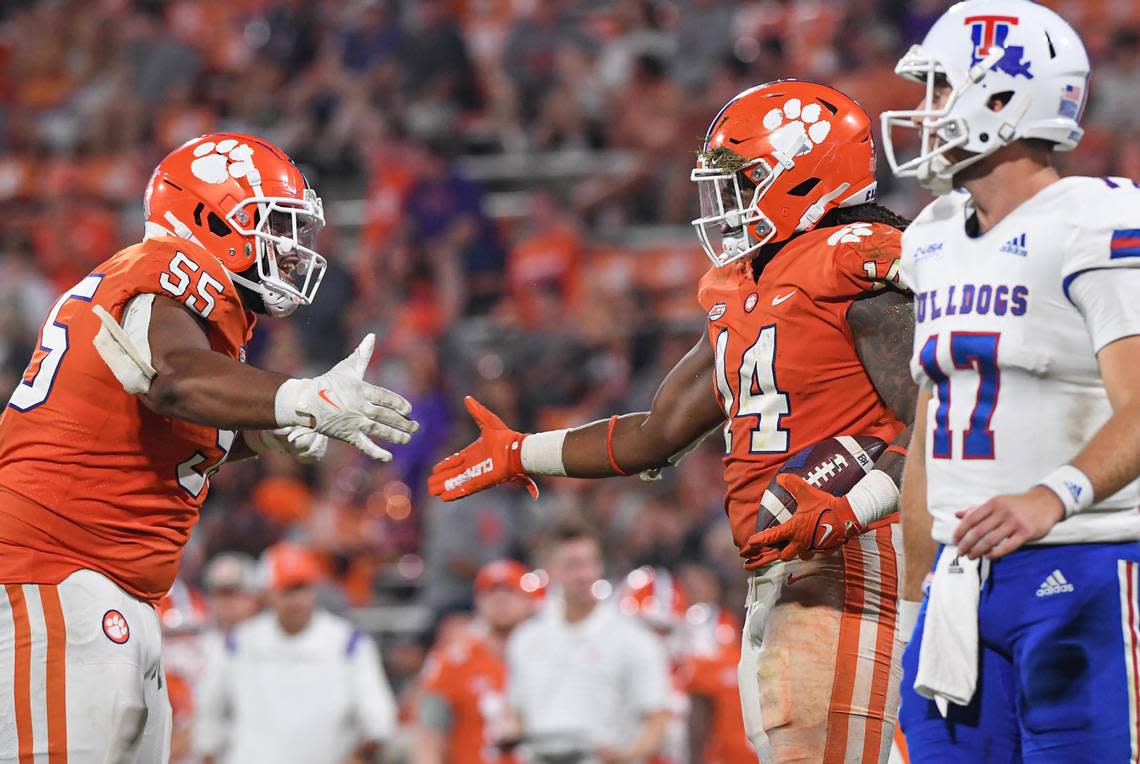 Sep 17, 2022; Clemson, South Carolina, USA; Clemson Tigers defensive tackle Payton Page (55) congratulates linebacker Kevin Swint (14) after his fumble recovery against Louisiana Tech Bulldogs quarterback Parker McNeil (17) during the fourth quarter at Memorial Stadium.