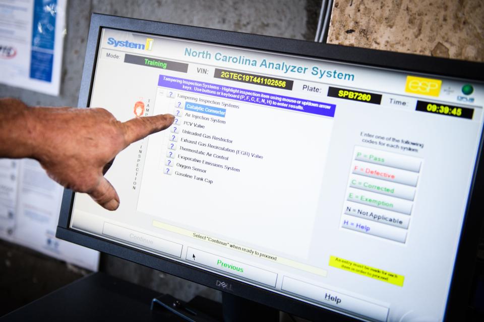 Mechanic John Green points out some of the items on an emissions test at Tire Sales & Service on Person St., Monday, Oct. 2, 2023.