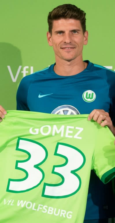 Wolfsburg's new signing, striker Mario Gomez, poses for a photo during a press conference in Wolfsburg, on August 18, 2016