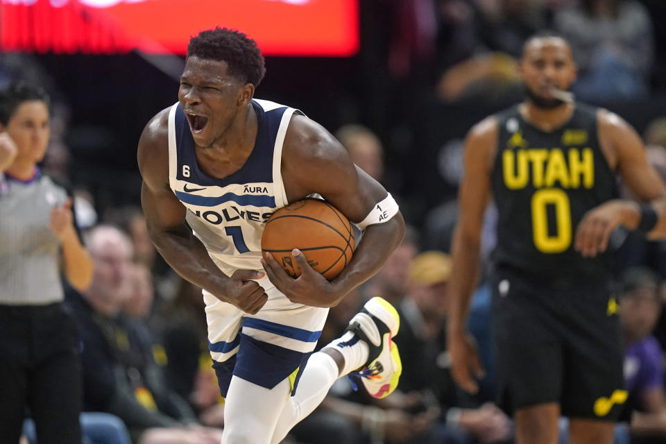 Minnesota Timberwolves guard Anthony Edwards (1) reacts as he runs up court during the first half of the team's NBA basketball game against the Utah Jazz on Friday, Dec. 9, 2022, in Salt Lake City. (AP Photo/Rick Bowmer)