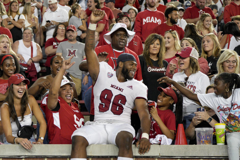 Miami (Ohio) defensive lineman Kobe Hilton (96) celebrates with fans after an NCAA college football game against Cincinnati, Saturday, Sept. 16, 2023, in Cincinnati. (AP Photo/Jeff Dean)