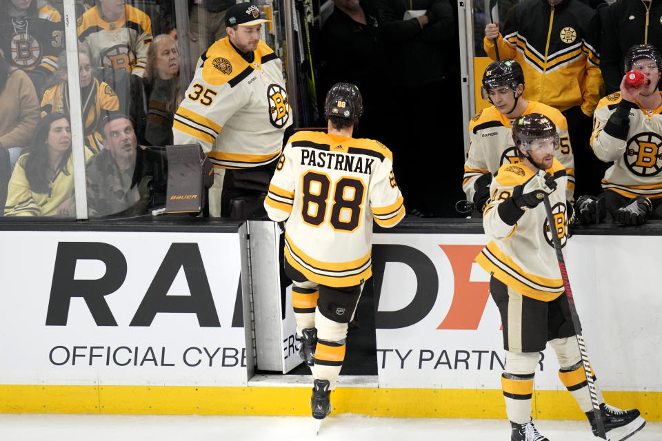 Boston Bruins right wing David Pastrnak (88) leaves the game after being charged with a game misconduct after boarding New York Rangers' Ryan Lindgren during the second period of an NHL hockey game, Saturday, Dec. 16, 2023, in Boston. (AP Photo/Charles Krupa)