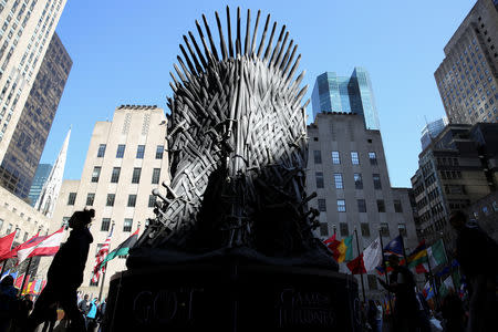 FILE PHOTO: People walk past a large replica of the iron throne before the premiere of the final season of "Game of Thrones" at Radio City Music Hall in New York, U.S., April 3, 2019. REUTERS/Caitlin Ochs/File Photo