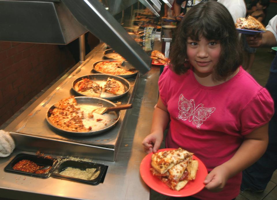 Savannah Burciaga was among hundreds who took part in GattiTown’s free pizza buffet giveaway July 7, 2010. Diners ate about $3,000 worth of free food per hour.