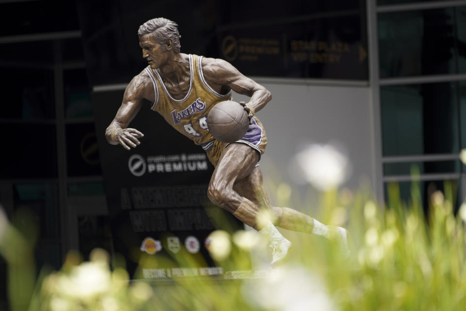 A statue of Jerry West is displayes outside of Crypto.com Arena Wednesday, June 12, 2024, in Los Angeles. West, who was selected to the Basketball Hall of Fame three times in a storied career as a player and executive, and whose silhouette is considered to be the basis of the NBA logo, died Wednesday morning. He was 86. (AP Photo/Richard Vogel)