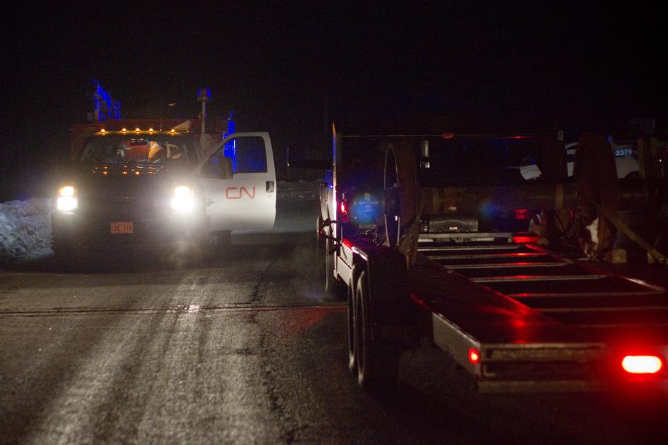 Canadian National Railway personnel respond after a train derailment outside of Plaster Rock, New Brunswick, Canada on Wednesday Jan. 8, 2014. A Canadian National Railway freight train carrying crude oil and propane derailed Tuesday night in a sparsely populated region of northwestern New Brunswick. More than 100 residents remained evacuated from their homes. There were no deaths or injuries. (AP Photo/The Canadian Press, Tom Bateman)