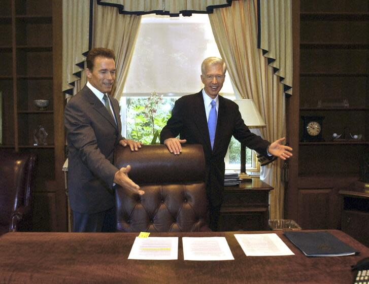 FILE — In this Oct. 23, 2003 file photo, Gov.-elect Arnold Schwarzenegger, left, and Gov. Gray Davis joke with each other as Davis shows Schwarzenegger the governor's private office at the Capitol in Sacramento, Calif. The two met for the first time since the voters elected Schwarzenegger to replace Gov. Gray Davis in the historic 2003 recall election. Today's California electorate is less Republican and more Asian and Latino than it was 18 years ago, trends that favor Newsom. (AP Photo/Rich Pedroncelli, File)