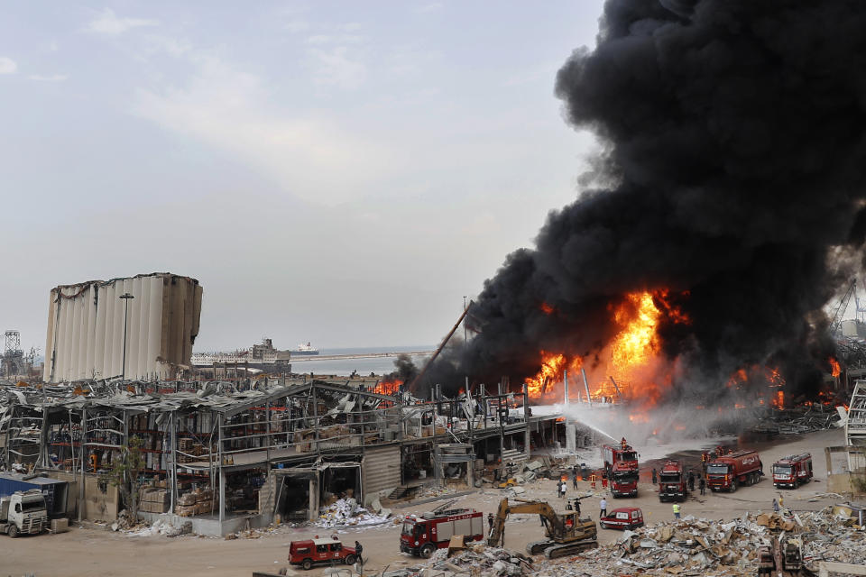 Firefighters work to extinguish a fire at warehouses at the seaport in Beirut, Lebanon, Thursday, Sept. 10. 2020. A huge fire broke out Thursday at the Port of Beirut, triggering panic among residents traumatized by last month's massive explosion that killed and injured thousands of people. (AP Photo/Hussein Malla)