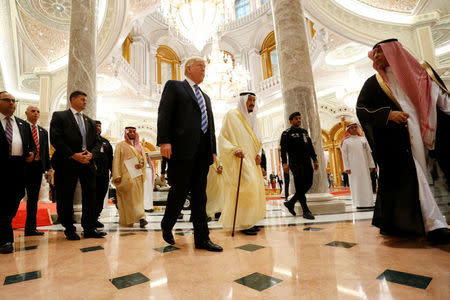 U.S. President Donald Trump (center L) walks with Saudi Arabia's King Salman bin Abdulaziz Al Saud (center R) to deliver remarks to the Arab Islamic American Summit in Riyadh, Saudi Arabia May 21, 2017. REUTERS/Jonathan Ernst