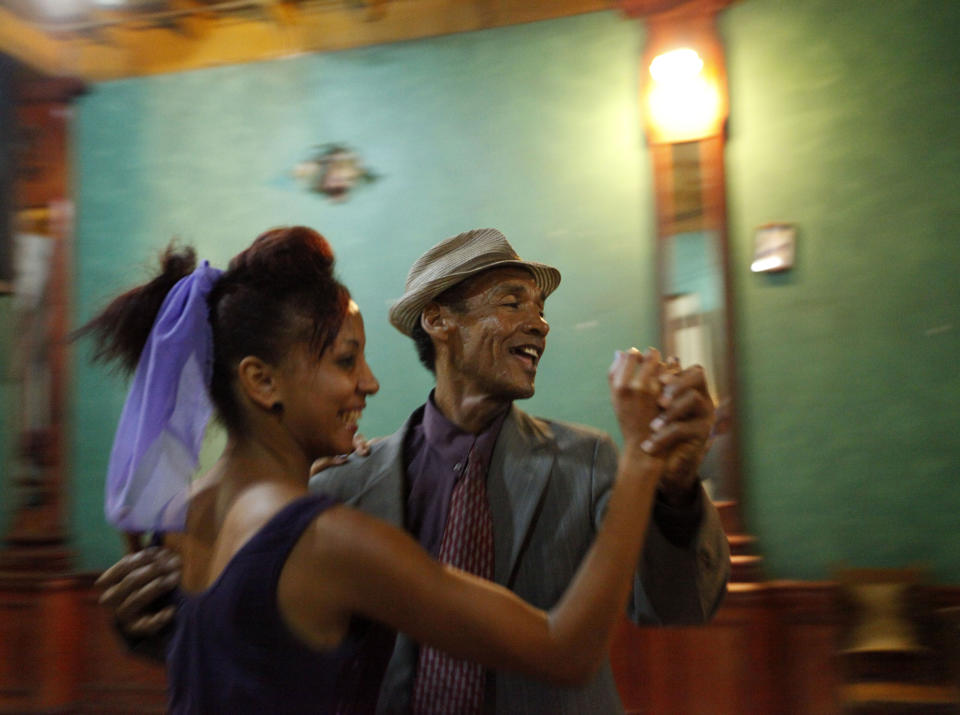 This April 26, 2012 photo shows performers dancing to live music at Casa de la Trova, house of troubadors, in Santiago de Cuba, Cuba. Music is an integral part of Cuban culture, particularly in Santiago de Cuba, birthplace of composer Compay de Segundo, who was well known before, but became an international celebrity when the Ry Cooder film, "The Buena Vista Social Club" was released. (AP Photo/Kathy Willens)