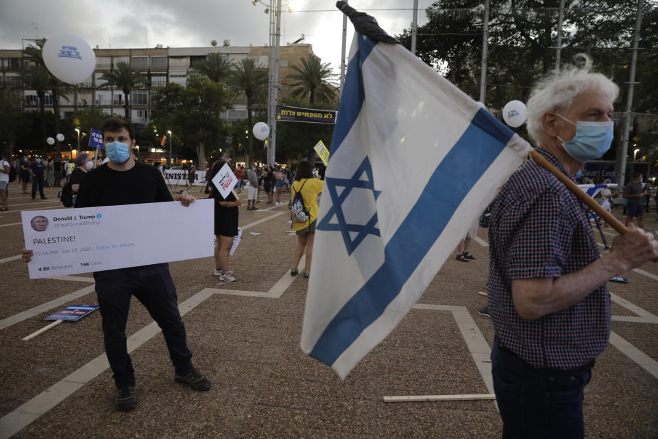 People take part in a protest against Israel's plan to annex parts of the West Bank and Trump's mideast initiative, in Tel Aviv, Israel, Tuesday, June 23, 2020. (AP Photo/Sebastian Scheiner)