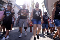 People arrive at Universal Studios in Universal City, Calif., Tuesday, June 15, 2021. On Tuesday, California lifted most of its COVID-19 restrictions and ushered in what has been billed as the state’s “Grand Reopening.” (AP Photo/Ringo H.W. Chiu)