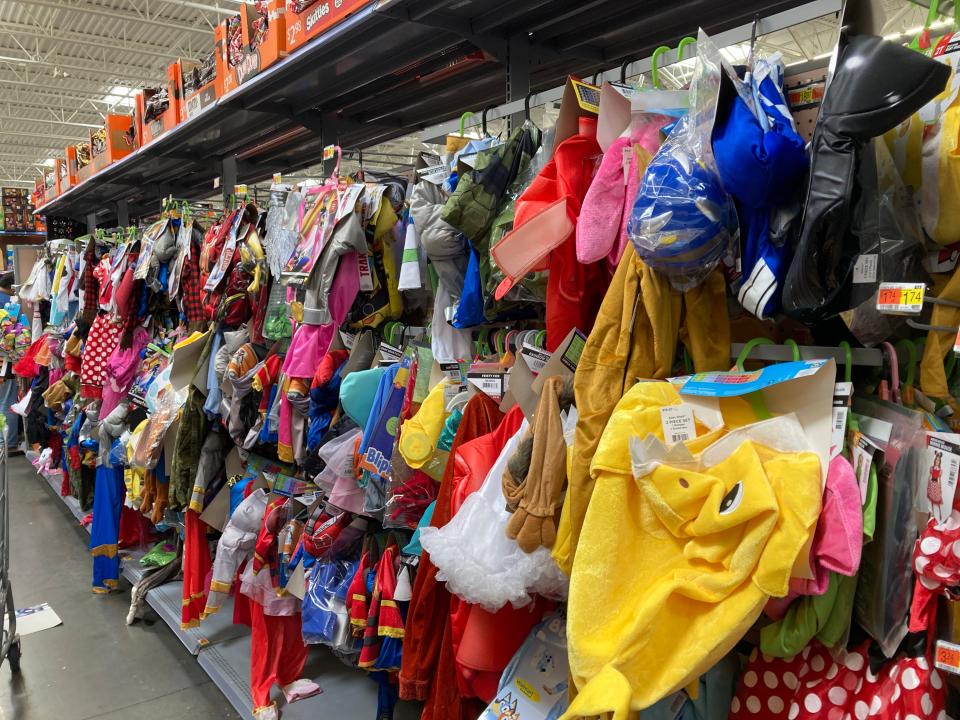 An aisle of Halloween costumes at Walmart.