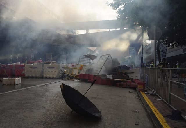 An umbrella is abandoned near barricades