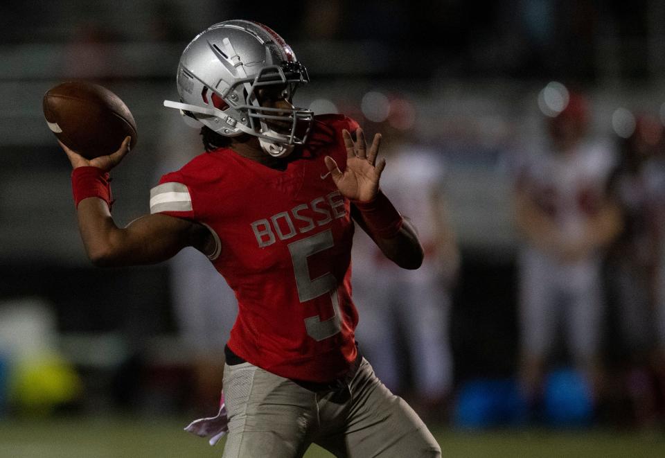 Bosse’s Elijah Wagner (5) passes as the Bosse Bulldogs play the Harrison Warriors at Enlow Field in Evansville, Ind., Friday, Oct. 13, 2023.