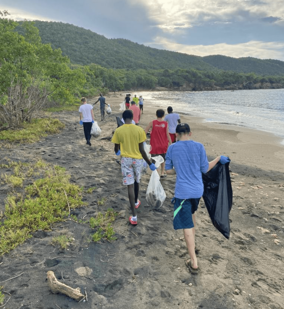 Boys at the Atlantis Leadership Academy in Treasure Beach pick up trash. (Courtesy Tarah Fleischman)