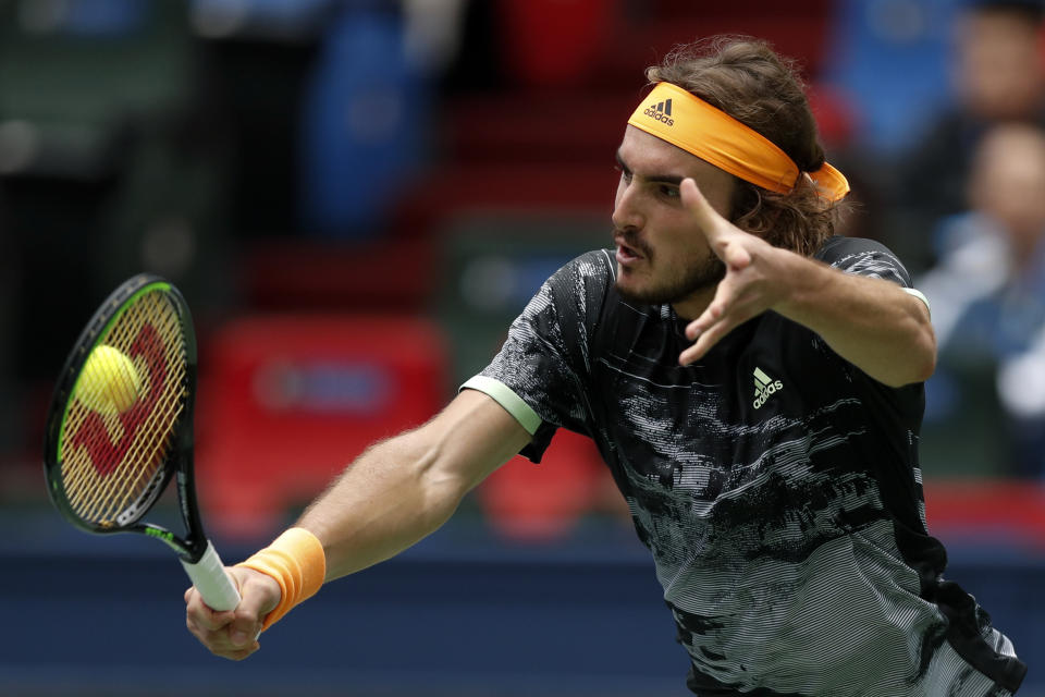 Stefanos Tsitsipas of Greec hits a return against Felix Auger-Aliassime of Canada during the men's singles match at the Shanghai Masters tennis tournament at Qizhong Forest Sports City Tennis Center in Shanghai, China, Wednesday, Oct. 9, 2019. (AP Photo/Andy Wong)