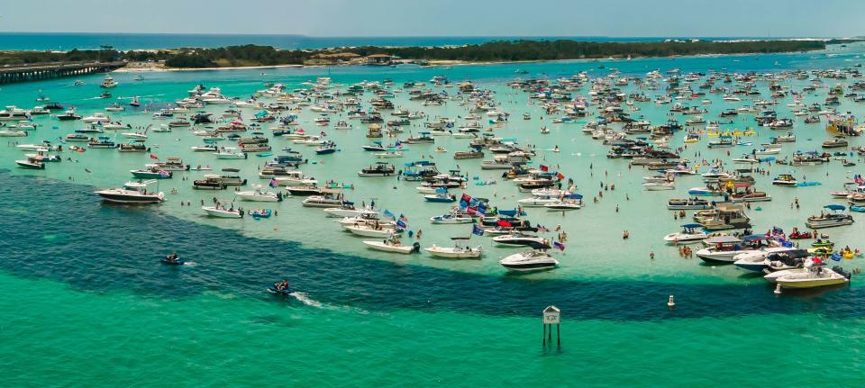 Boats line the shallows of Crab Island on the Fourth of July in 2020.
