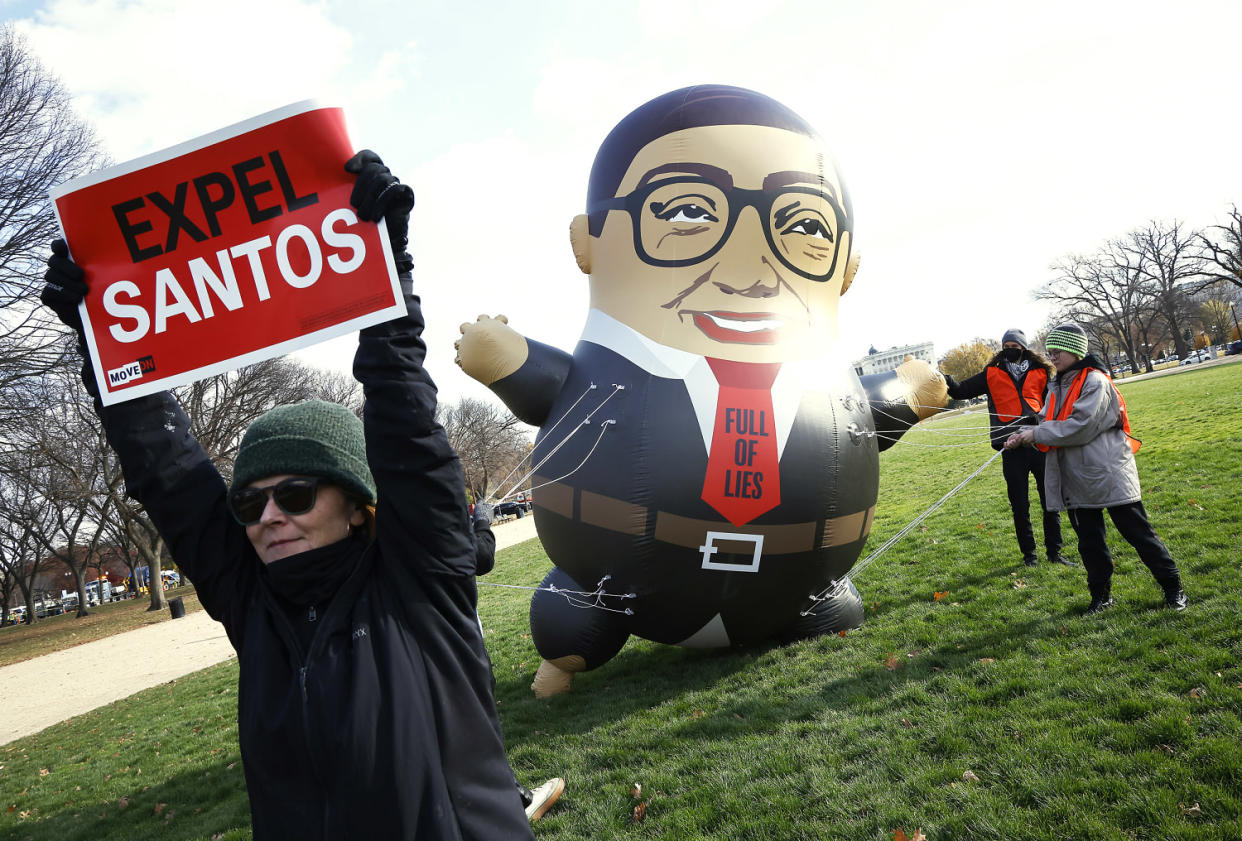 Activists hold a large inflatable balloon of Rep. George Santos as they advocate for his expulsion.  (Paul Morigi / Getty Images)