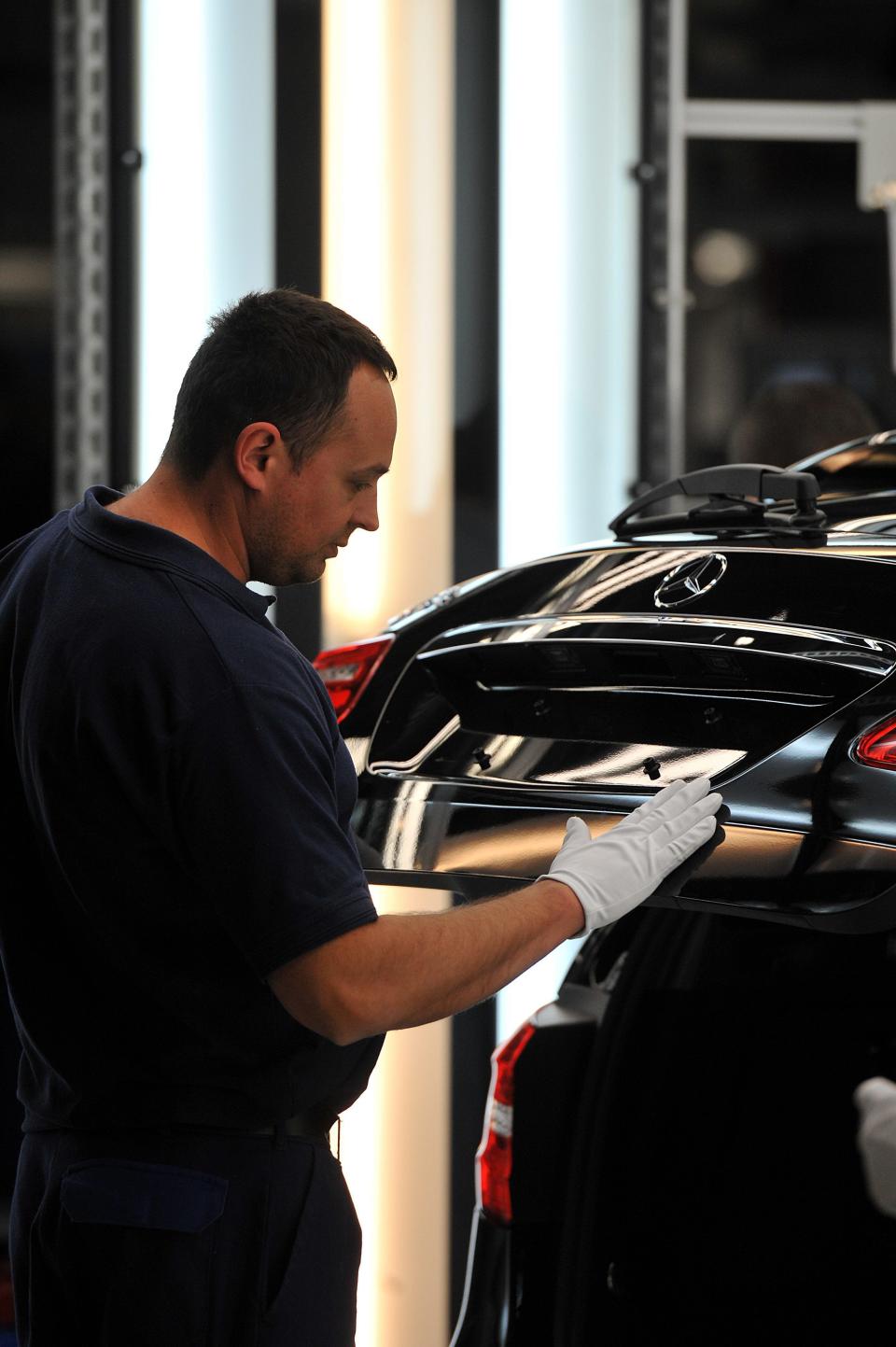 An employee works on a car in the assembly hall in the new Mercedes Benz plant in Kecskemet, 83 kilometers southeast of Budapest, Hungary, prior to the the official inauguration ceremony of the Kecskemet Mercedes factory on Thursday, 29 March, 2012. The new Mercedes plant built on a basic territory of 441 hectares with an investment of 800 million euros has a yearly capacity of 100 thousand cars of two types of compact B-Class produced by 2,500 employees. (AP Photo/MTI, Tamas Kovacs)