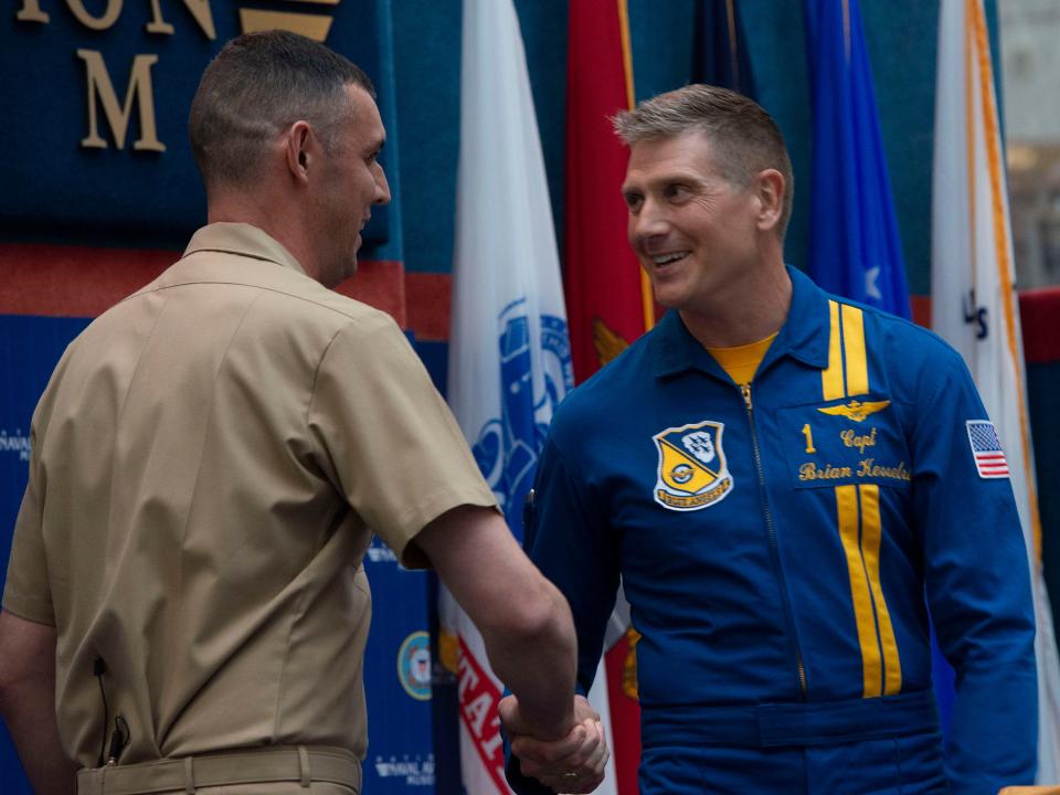 Blue Angels Commanding Officer Capt. Brian Kesselring, right, congratulates Cmdr. Alex Armatas on being selected as the team's new commanding officer for 2023 and 2024 during a press conference Tuesday at the National Naval Aviation Museum at NAS Pensacola.