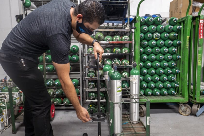 GLENDALE, CA - AUGUST 19: Edmond Manukyan moving oxygen cylinders at A-1 Oxygen, Inc on Thursday, Aug. 19, 2021 in Glendale, CA. A-1 Oxygen, Inc. provides customers with medical equipment. (Francine Orr / Los Angeles Times)