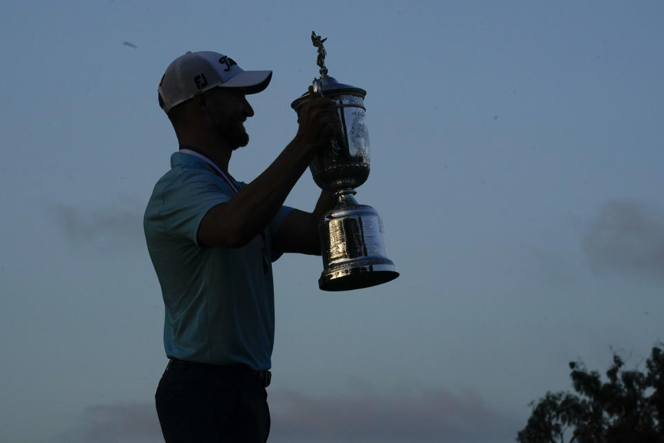 Wyndham Clark holds the trophy after winning after the U.S. Open golf tournament at Los Angeles Country Club on Sunday, June 18, 2023, in Los Angeles. (AP Photo/Marcio J. Sanchez)